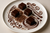 generate a delicious chocolate plate with grated chocolate, chocolate sauce, chocolate fudge and chocolate swirls